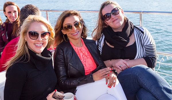 3 women on deck of yacht