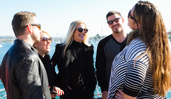 Affboost Media employees standing on pier talking